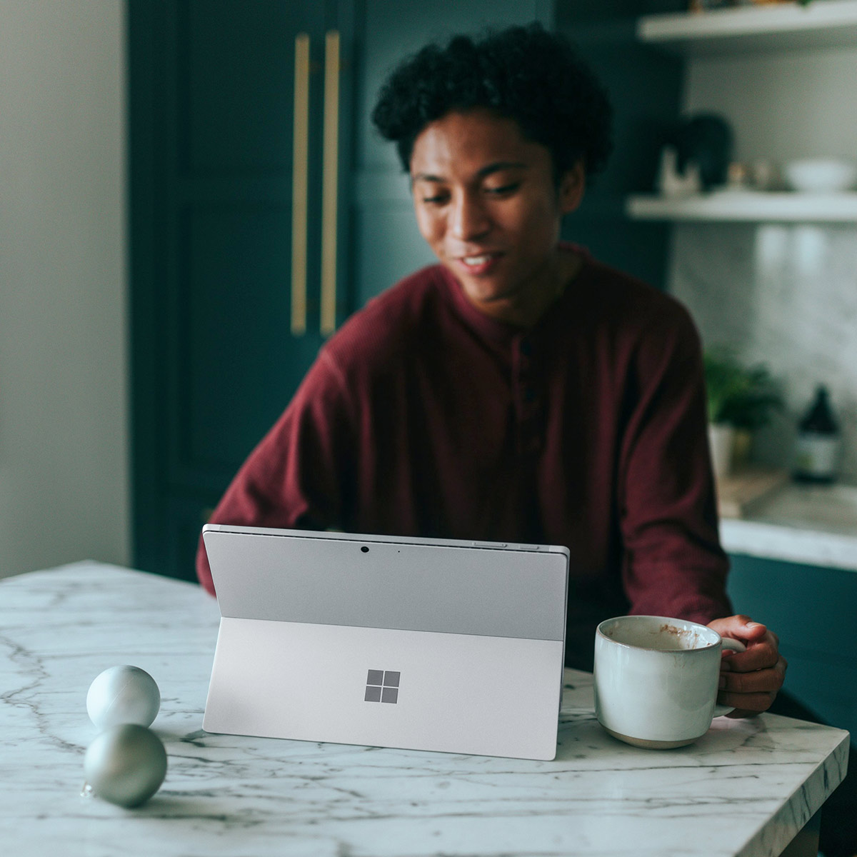 Woman at her desk with a laptop, in a moment of pause